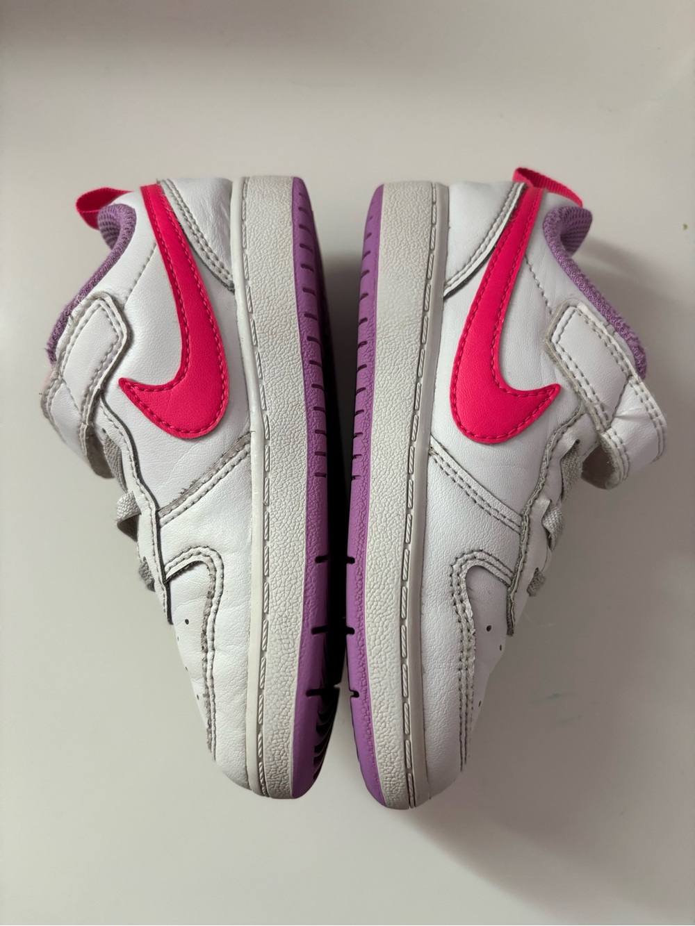 Nike White Sneakers with Bright Pink Swoosh and Lavender Soles